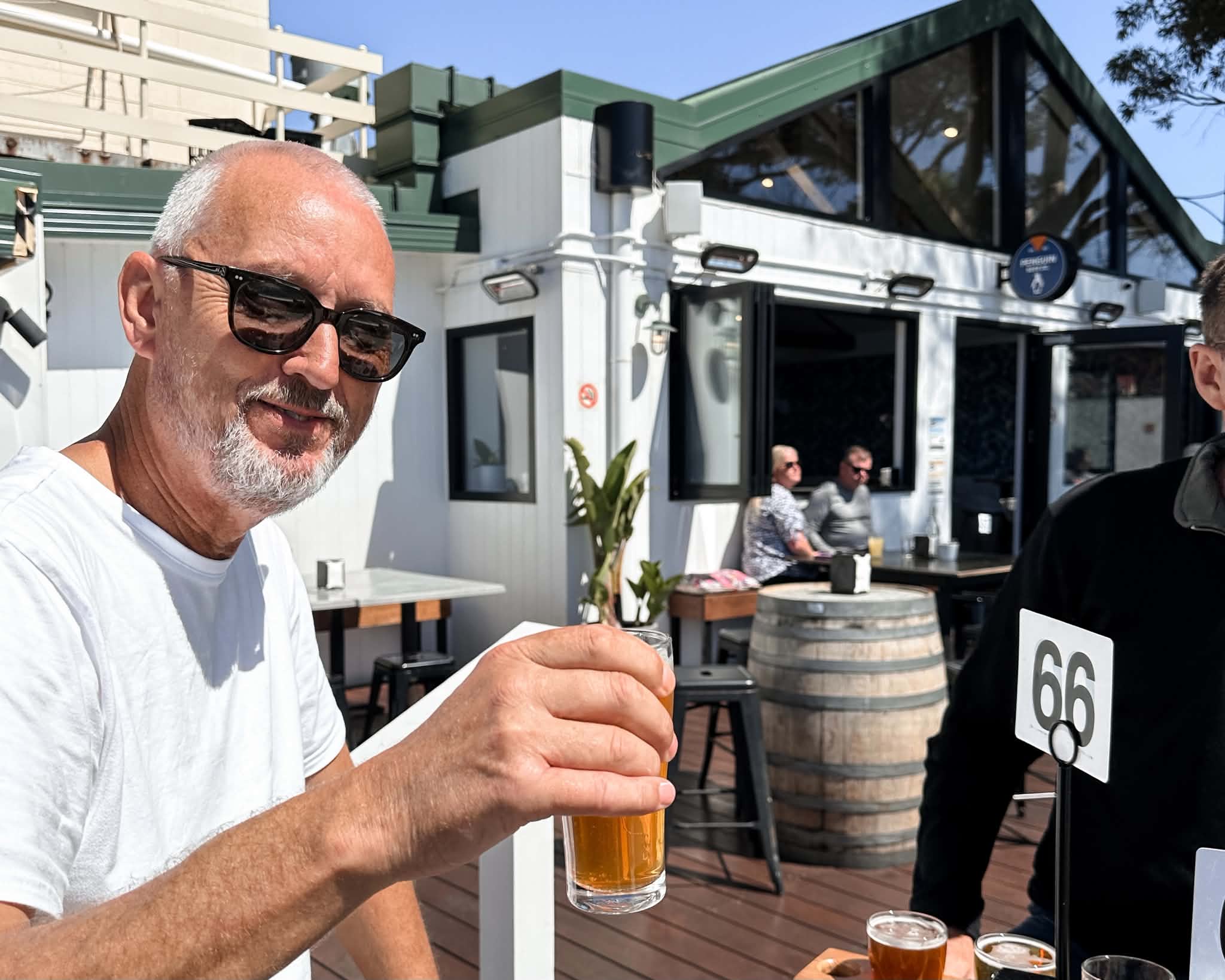 Visitor enjoying a craft beer at Penguin Beer Co. on the waterfront in Penguin, Tasmania