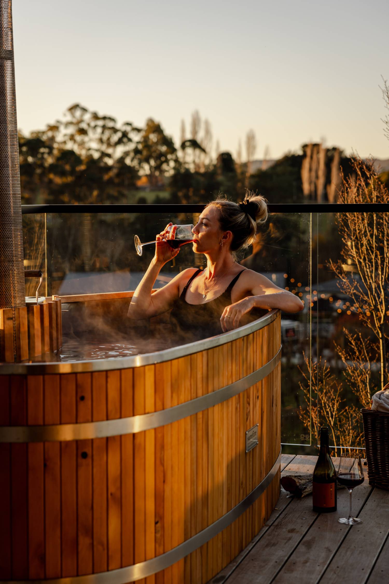 Guest relaxing in an outdoor hot tub at Meander Valley Vineyard in Tasmania